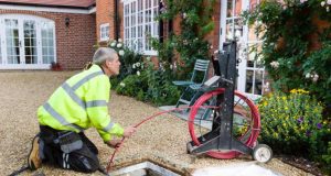 The Advantages of Drain Cleaning: Why Is It Vital? Plumber clearing a blocked household drain