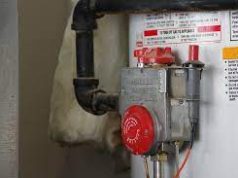 Some interesting facts About Water Heaters and safety tips Technician inspecting a home water heater for safety