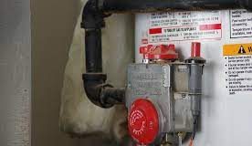 Some interesting facts About Water Heaters and safety tips Technician inspecting a home water heater for safety