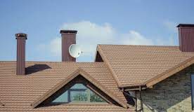 The Ultimate Guide to Choosing the Right Roofing Material Roofer installing shingles on a house roof